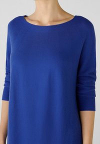Maglione azzurro lavorato a maglia con scollatura a barca, maniche 3/4 e un motivo testurizzato. Materiale morbido con una finitura liscia. Design semplice e moderno.
