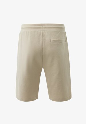 Beige Freizeithose mit elastischem Bund und einer einzelnen Leistentasche auf der Rückseite, von hinten auf weißem Hintergrund dargestellt.