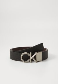Black leather belt with a textured finish, featuring a silver rectangular buckle with a circular "CK" logo. Brown interior lining visible.