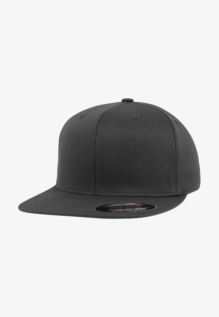 Black snapback cap made of textured fabric with a flat brim and stitched vent holes, featuring a circular logo patch on the brim.