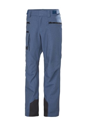Blauwe skibroek gemaakt van duurzaam materiaal met een gestructureerde afwerking. Voorzien van twee ritszakken en zwarte versterkte onderdelen.