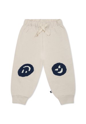 Pantaloni jogger in cotone beige con vita elasticizzata e coulisse. Presentano disegni di faccine sorridenti tuftate in navy sulle ginocchia e polsini a costine.