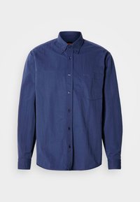 Cămașă albastru închis cu nasturi, guler ascuțit, mâneci lungi, buzunar singular la piept și broderie subtilă cu logo. Material neted și ușor.