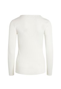 Top lungo bianco a maniche lunghe con scollatura a barchetta, motivo a pois testurizzati, vestibilità slim e tessuto morbido e leggero. La vista posteriore mostra una finitura liscia.