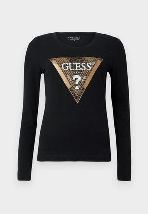 Maglietta nera a maniche lunghe con triangolo dorato e stampa leopardata che presenta la parola "GUESS" e un punto interrogativo al centro.