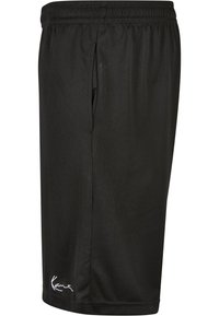 Shorts de sport noirs en tissu en mesh respirant. Comprend une taille élastique et des poches latérales. Détails de logo discrets en bas.
