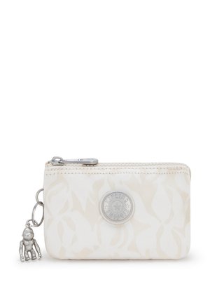 White fabric wallet with wavy pattern, zip closure, silver hardware, and a decorative keychain featuring a small monkey figure.