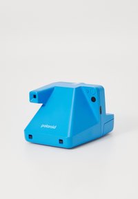 Polaroid camera in bright blue, triangular shape, plastic material, featuring a lens and various buttons on one side, compact design.