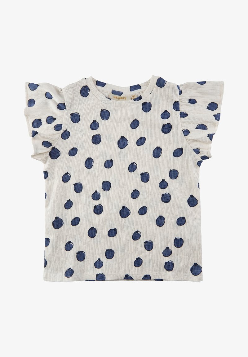 Biała koszula krótki rękaw w granatowe kropki; posiada falbaniaste rękawy i teksturowany materiał, co dodaje jej wymiaru.