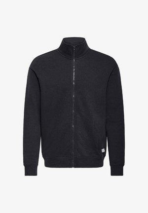 Zwarte sweatvest met rits en hoge kraag, gemaakt van zacht materiaal, met geribde manchetten en een klein merkembleem aan de onderzijde.