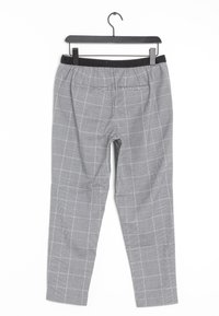 Pantalons à carreaux gris avec une taille élastique noire, présentant une légère tapered et deux poches arrière. Étiquette accrochée en haut.