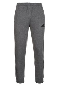 Grijze sweatpants van zacht materiaal, met een elastische tailleband, boordjes bij de enkels en een zwart Adidas-logo op de linker dij.