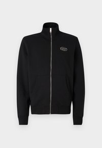 Sweatshirt preto com fecho zip, gola alta, bolsos laterais e punhos canelados. Apresenta um pequeno logótipo no peito, feito de tecido macio.
