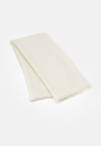 Écharpe beige clair en tissu doux, avec un motif subtil de cercles. Les bords sont frangés pour apporter de la texture et du détail.