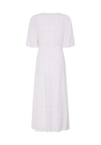 Robe midi blanche avec manches courtes évasées et petit motif à pois rouges, montrée de dos sur un fond uni.