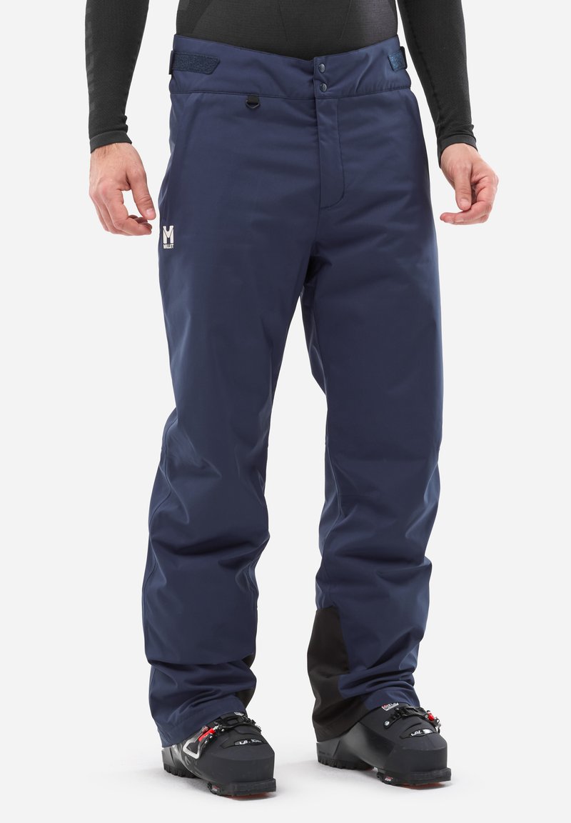 Pantalons de ski imperméables en marine, fabriqués en matériau synthétique, avec une fermeture à glissière, un bouton et une taille ajustable. Comprend un détail de logo.