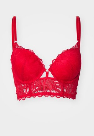 Bralette en dentelle rouge avec armatures, bords festonnés, bretelles réglables et une découpe décorative au centre. Présente des motifs floraux complexes.