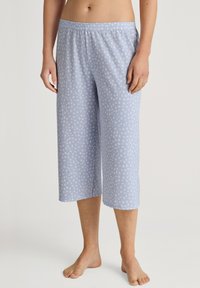 Light blue cropped pajama pants in soft fabric, featuring white polka dot patterns, elastic waistband, and a relaxed fit.