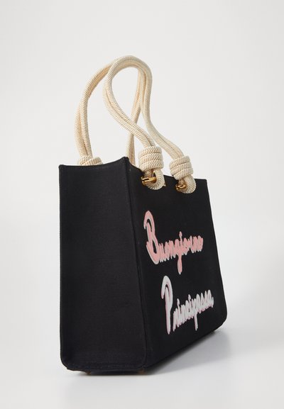 Black canvas tote bag with cream rope handles, featuring embroidered pink text "Buongiorno Principessa" on the front.