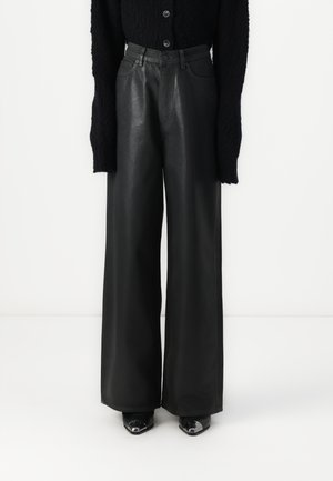 Black leather wide-leg trousers with a high waist, featuring front pockets and a smooth texture, paired with black heeled shoes.