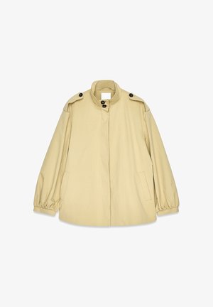 Beige loose-fitting jacket made of lightweight material, featuring a high collar, large buttons, and elasticized cuffs with side pockets.