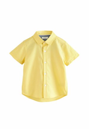 Chemise jaune à manches courtes en coton. Présente un col et une fermeture à boutons sur le devant, avec un ourlet arrondi et une texture lisse.