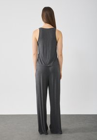 Gray sleeveless top and wide-leg pants, made from soft, lightweight fabric. Smooth texture, relaxed fit, with a simple design.