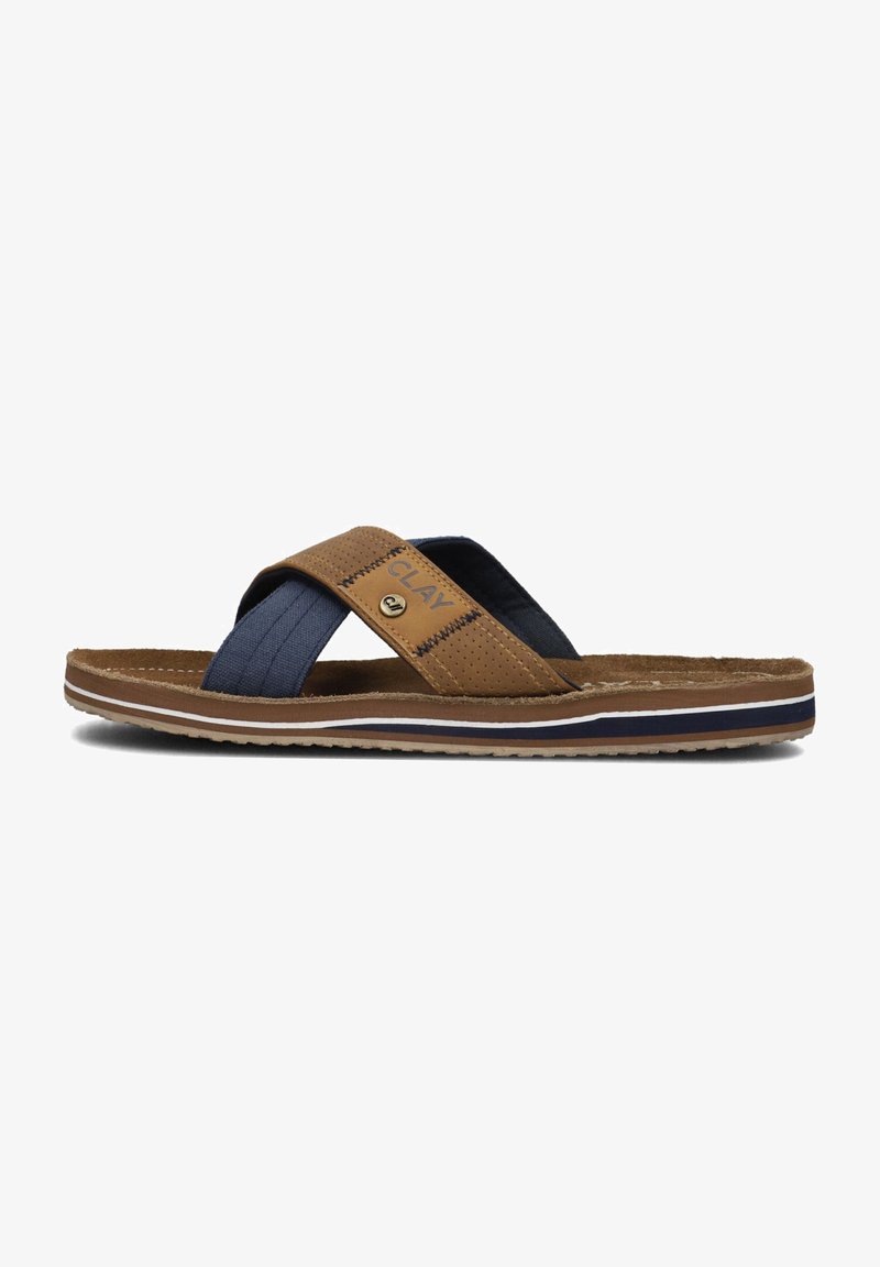 Brown and navy slide sandal with cross straps, featuring a textile upper and contrasting white and navy sole accents. Textured detailing present.