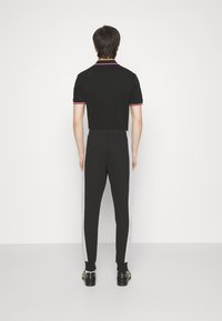 Lacoste Trainingsbroek - black/silver chine