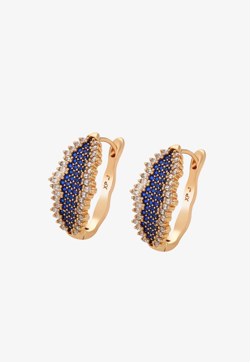 Orecchini a cerchio in tonalità oro con accenti di gemme blu e trasparenti. Il design è allungato con una superficie ondulata e testurizzata.