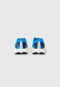 Blue and navy athletic shoes with a textured mesh upper, padded collar, and white sole. Features reflective accents and a low-profile design.