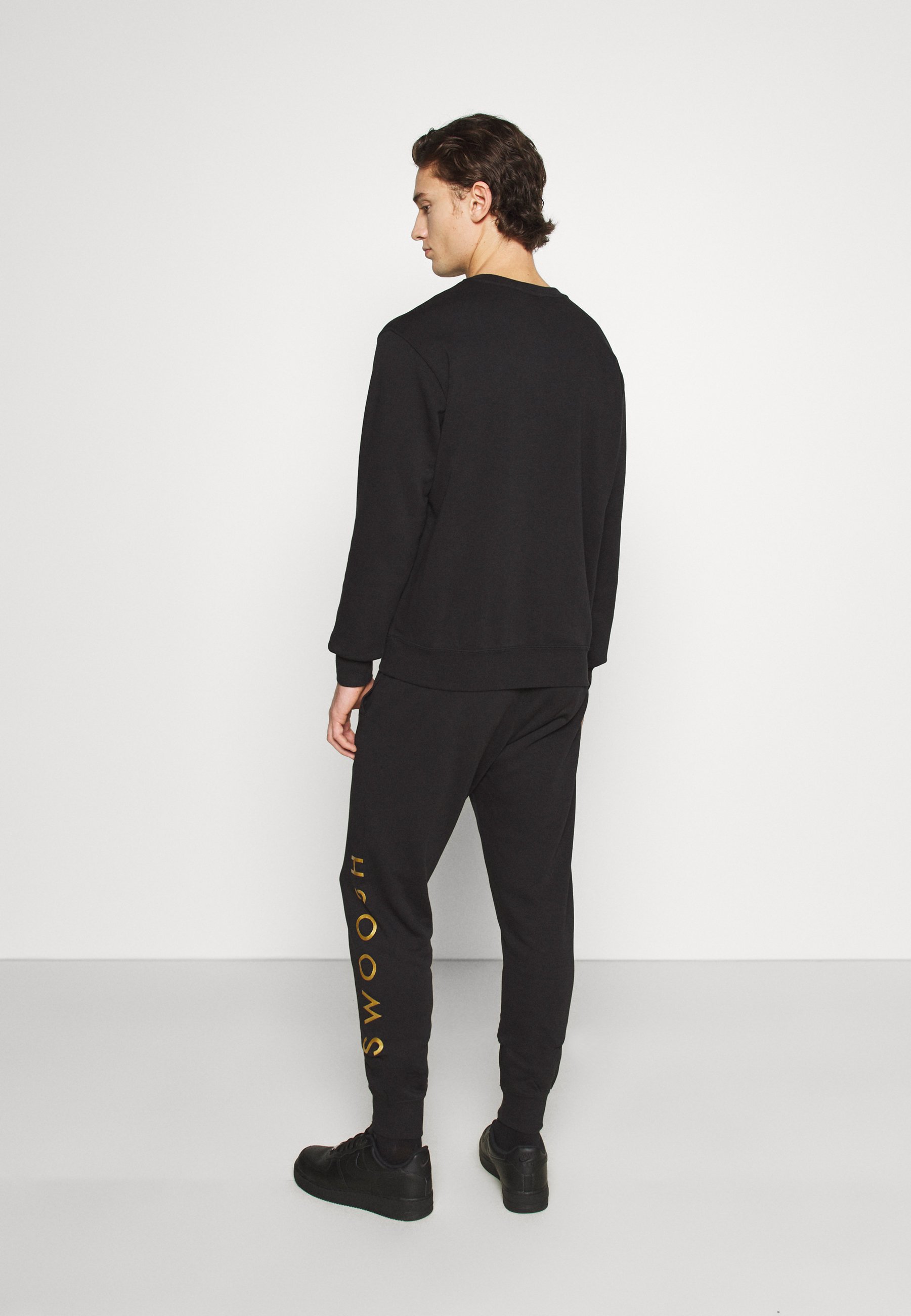 nike black and gold tracksuit
