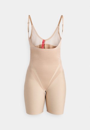 Nude bodysuit made of smooth, stretchy fabric, featuring thin adjustable straps, a scoop neckline, and a mid-thigh length with seamless design.