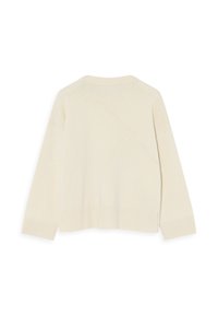 Tejelt, krémszínű pulóver, bordázott hemmel és mandzsettával, ívelt varrás részletekkel. Puha tapintás és laza szabás.