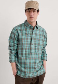 Turquoise plaid shirt with long sleeves, button-down collar, and a chest pocket. The pattern features orange and brown lines.