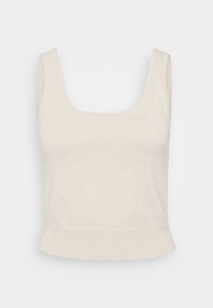 Cream-colored crop top made of soft, ribbed fabric. Features a square neckline, wide straps, and a fitted hem. Minimalist design.