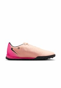 Nike turf shoes in pink gradient with textured upper, black accents, and a rubber outsole featuring prominent tread for grip.