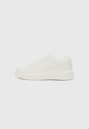 White sneakers with a smooth leather upper, flat lace closure, a thick white sole, and subtle perforations for ventilation.