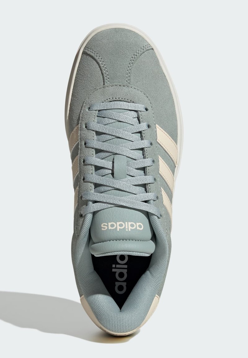 Light blue suede sneakers with beige stripes, flat laces, and a padded collar. Black insole with white logo detail. Rounded toe design.