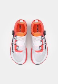 Trail running shoes featuring a white mesh upper, bright orange accents, black laces, and a distinctive rubber sole with a textured grip.