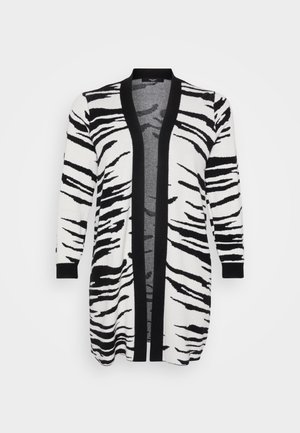 Long cardigan avec un motif rayé noir et blanc de zèbre, avec une bordure noire le long de l'avant ouvert et des manches. Tissu texturé.