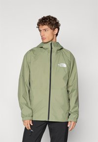 Wasserabweisende olivgrüne Jacke mit Reißverschluss, elastischen Bündchen und Logo-Akzent; verfügt über eine Kapuze und ein schlichtes, elegantes Design.