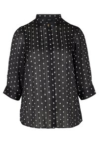 Blusa nera trasparente con righe verticali e pois bianchi, dotata di colletto alto, chiusura a bottoni e maniche a tre quarti.