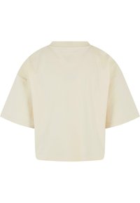 Short-sleeve, beige t-shirt with a crew neckline, featuring a relaxed fit and smooth texture. No visible patterns or hardware.