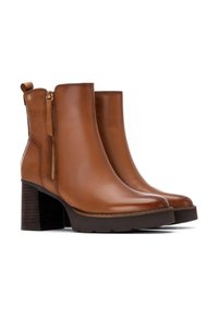 Botas de tobillo de cuero marrón con un tacón de bloque texturizado, cierre con cremallera lateral y un diseño minimalista. Cuenta con una pestaña en la parte posterior.