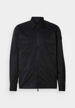 Black lightweight zip-up jacket made of smooth fabric, featuring two chest pockets and a classic collar with long sleeves.