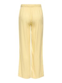 Pantalon jaune clair à taille élastique et jambe droite, vu de dos avec une texture de tissu lisse et douce.