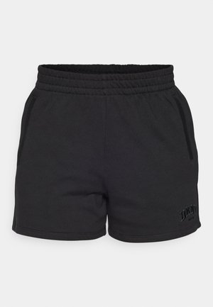 Black cotton athletic shorts with an elastic waistband, two side pockets, and subtle DKNY branding on the lower left hem.