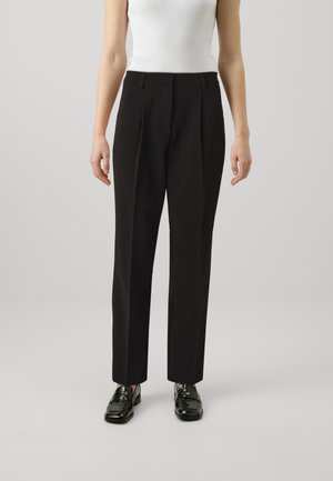 Black tailored pants with a high waist, featuring a straight leg design and subtle creases, paired with shiny black loafers.