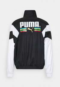 Black and white windbreaker jacket with a high collar, featuring a large white "PUMA" logo and colorful horizontal stripes at the back.